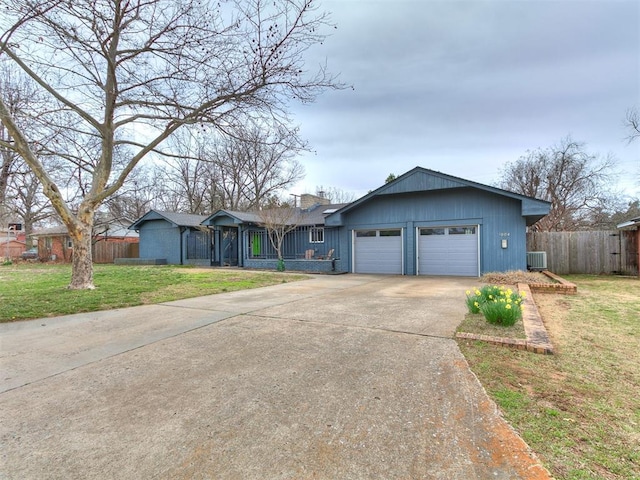 single story home with a front yard, fence, an attached garage, central AC, and concrete driveway