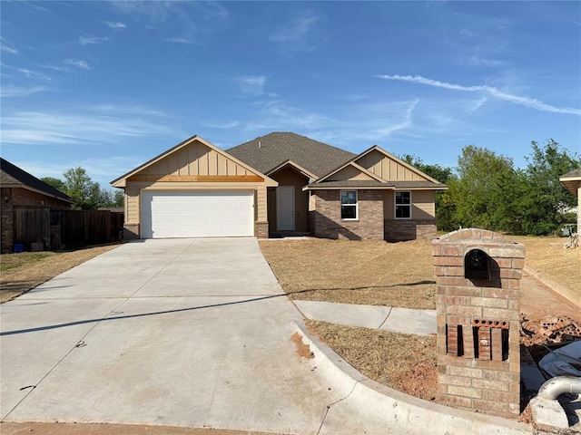 11601 SW 14th St, Yukon, OK 73099 - view of front of property featuring board and batten siding, an attached garage, and driveway