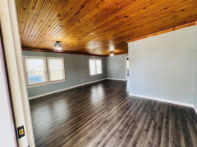 unfurnished room featuring dark wood finished floors, baseboards, and ornamental molding