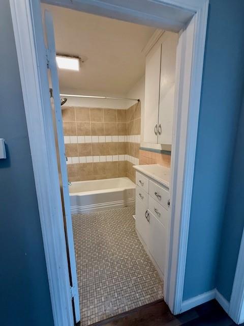 full bathroom featuring vanity, tile patterned floors, and shower / bathtub combination