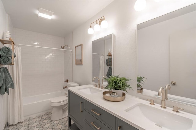 full bath featuring double vanity, toilet, shower / bath combo, and a sink