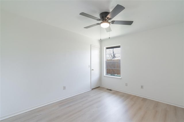 spare room featuring visible vents, ceiling fan, baseboards, and light wood-style floors