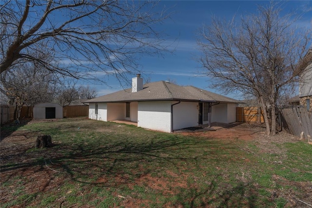 view of home's exterior with an outdoor structure, a yard, and a fenced backyard