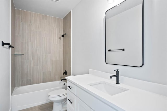 bathroom featuring vanity, toilet, and tub / shower combination