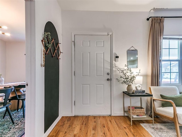 foyer featuring baseboards and light wood-style floors