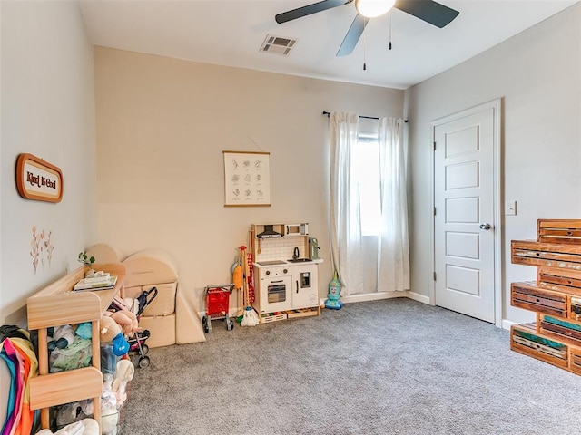 game room with carpet, a ceiling fan, visible vents, and baseboards