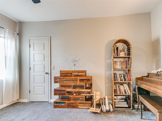 miscellaneous room with arched walkways, baseboards, and carpet floors