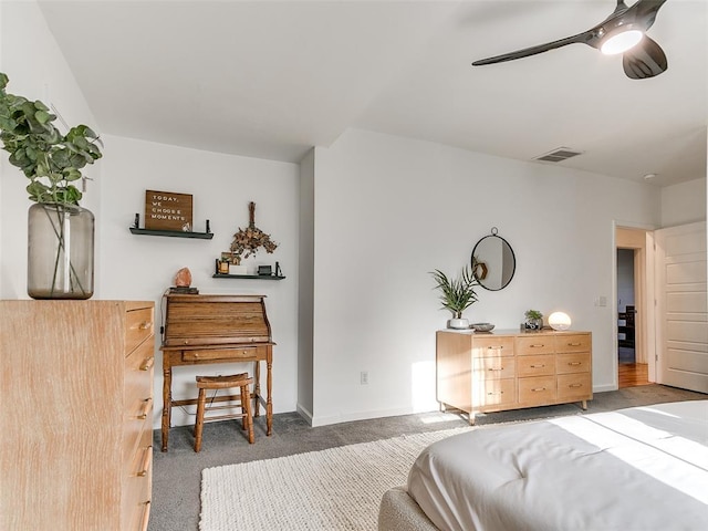 carpeted bedroom with visible vents, baseboards, and a ceiling fan