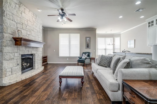 living area with dark wood-type flooring, ceiling fan with notable chandelier, visible vents, and ornamental molding