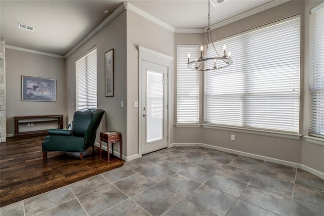 interior space featuring crown molding, a healthy amount of sunlight, visible vents, and a chandelier