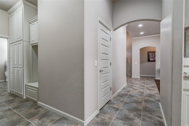 corridor featuring recessed lighting, baseboards, and arched walkways