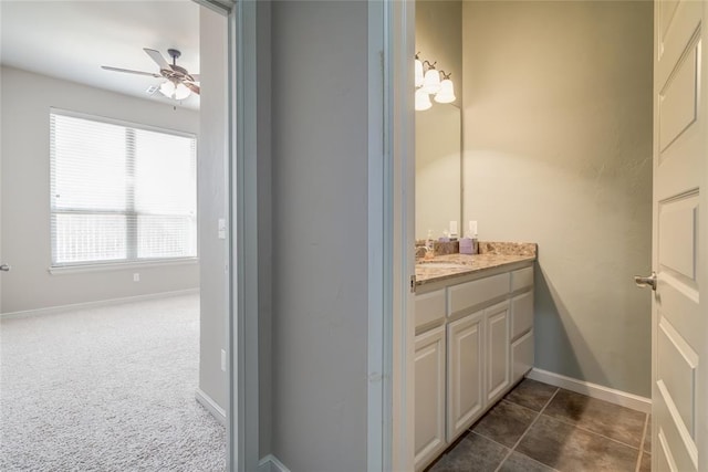 bathroom with tile patterned flooring, baseboards, vanity, and a ceiling fan