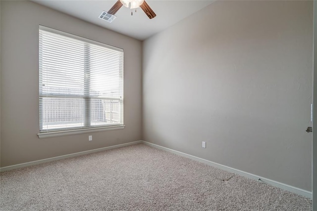 unfurnished room featuring carpet flooring, visible vents, baseboards, and ceiling fan