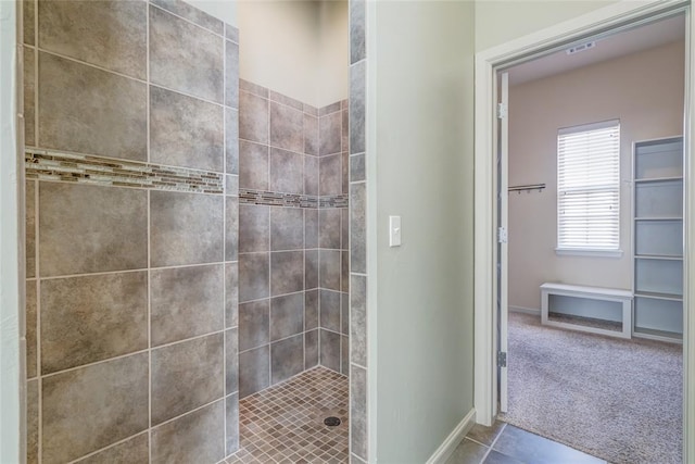 full bath with tile patterned floors, tiled shower, and baseboards