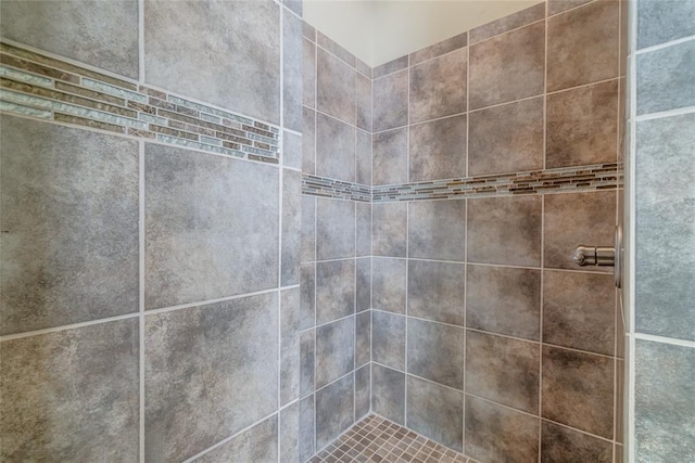 interior details with a tile shower