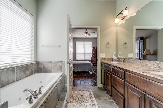 ensuite bathroom with a sink, a whirlpool tub, double vanity, and ensuite bathroom