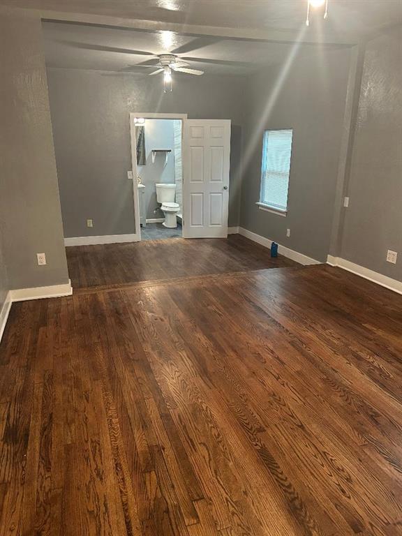 interior space with ceiling fan, wood finished floors, and baseboards