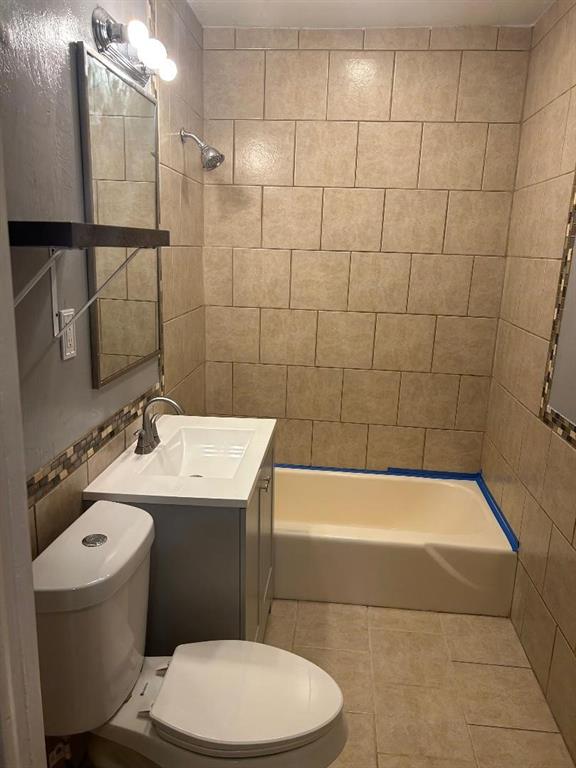 full bathroom with tile patterned floors, vanity, toilet, and tub / shower combination