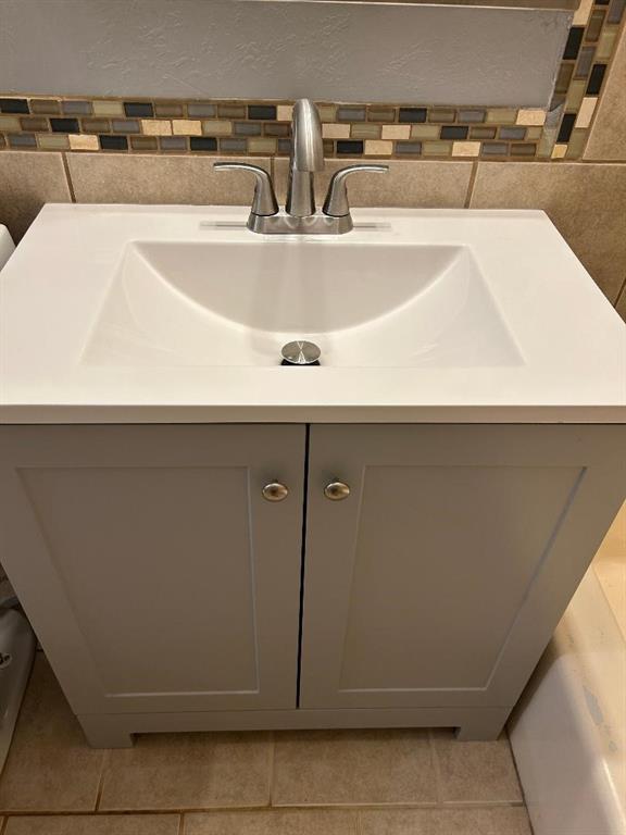 bathroom with tile patterned flooring and vanity