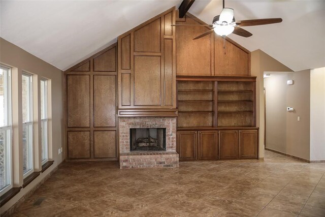 unfurnished living room with a brick fireplace, ceiling fan, and vaulted ceiling with beams