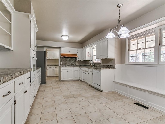 5700 N Billen Ave, Oklahoma City, OK 73112 - kitchen featuring visible vents, an inviting chandelier, white cabinets, white appliances, and a sink