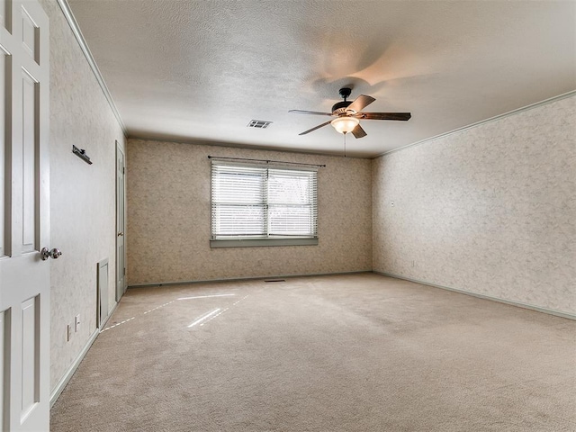 5700 N Billen Ave, Oklahoma City, OK 73112 - empty room with visible vents, ornamental molding, a ceiling fan, a textured ceiling, and light colored carpet