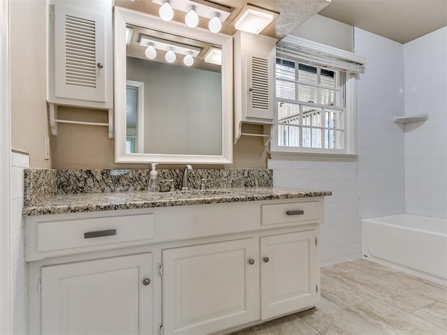 5700 N Billen Ave, Oklahoma City, OK 73112 - full bathroom featuring vanity, tile walls, and shower / bath combination