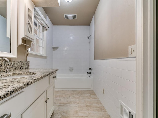 5700 N Billen Ave, Oklahoma City, OK 73112 - full bath with vanity, tile walls, bathing tub / shower combination, and visible vents