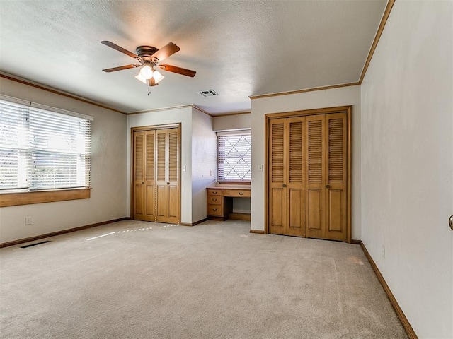 5700 N Billen Ave, Oklahoma City, OK 73112 - unfurnished bedroom with visible vents, multiple closets, light colored carpet, and baseboards