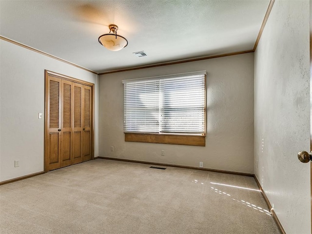 5700 N Billen Ave, Oklahoma City, OK 73112 - unfurnished bedroom featuring crown molding, carpet flooring, baseboards, and visible vents