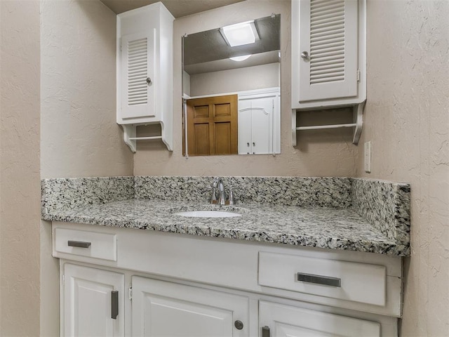5700 N Billen Ave, Oklahoma City, OK 73112 - bathroom with vanity and a textured wall
