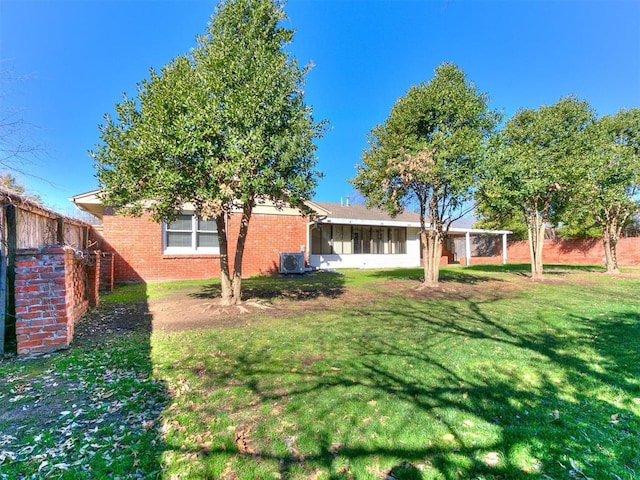 5700 N Billen Ave, Oklahoma City, OK 73112 - view of yard featuring cooling unit, fence, and a sunroom