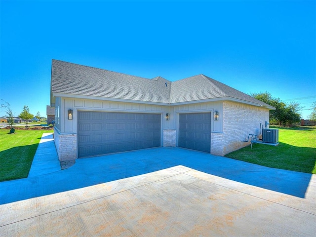 view of front of home with a front lawn, central AC unit, brick siding, and a shingled roof