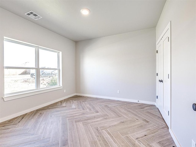 spare room with visible vents and baseboards