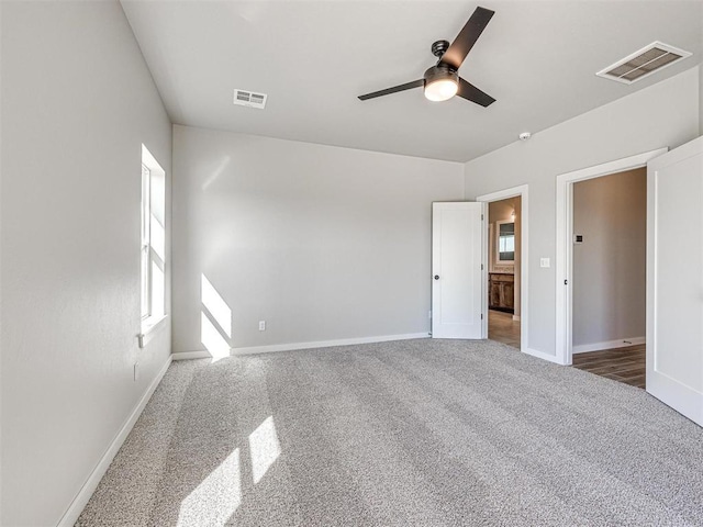 unfurnished bedroom featuring visible vents, carpet flooring, baseboards, and ceiling fan