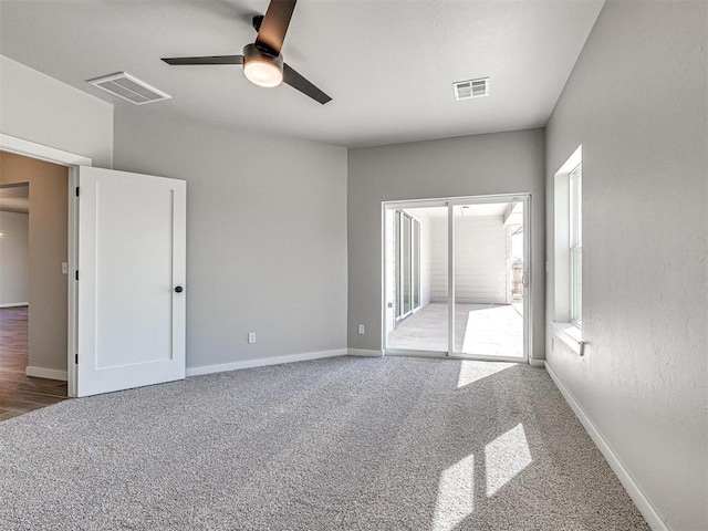 unfurnished bedroom with visible vents, baseboards, and carpet flooring