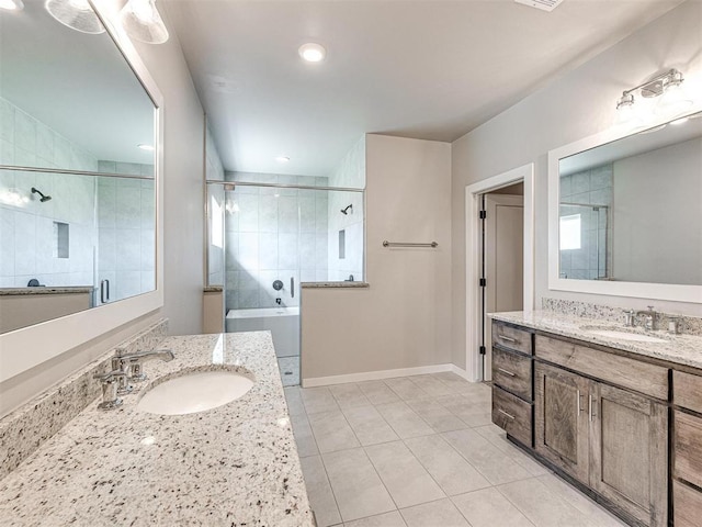 bathroom featuring a shower stall, two vanities, and a sink