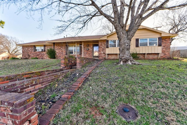 ranch-style home with brick siding and a front lawn