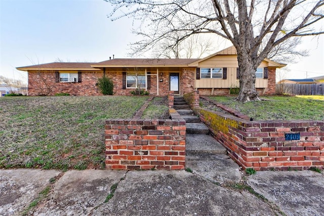 single story home featuring brick siding, a front yard, and fence