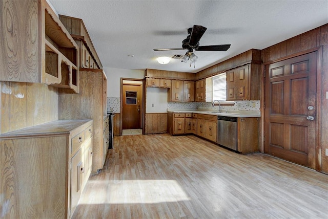 kitchen with ceiling fan, light countertops, light wood-style flooring, brown cabinetry, and stainless steel dishwasher