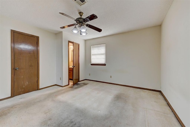 unfurnished bedroom with visible vents, baseboards, carpet floors, and a textured ceiling