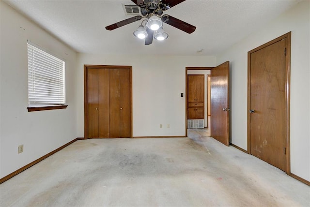 unfurnished bedroom with carpet flooring, ceiling fan, baseboards, and visible vents