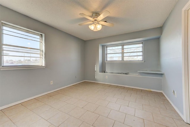 unfurnished room featuring baseboards, a textured ceiling, and ceiling fan