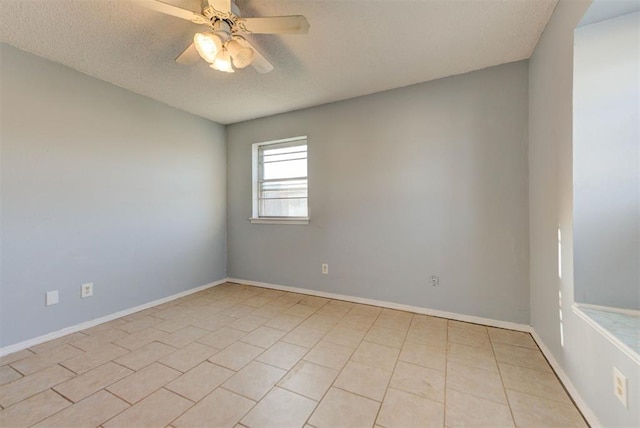 spare room featuring baseboards, a textured ceiling, and a ceiling fan