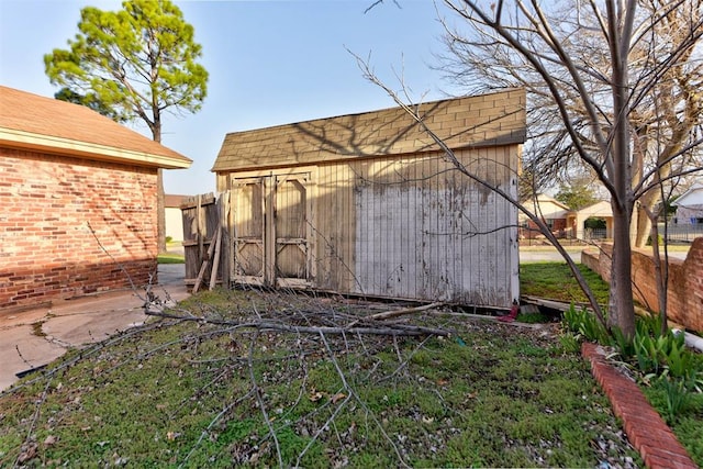 view of shed featuring fence