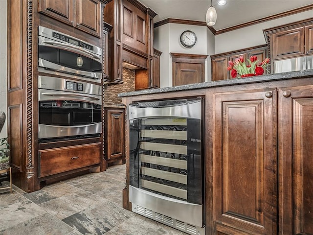 kitchen featuring stainless steel double oven, dark stone counters, decorative backsplash, wine cooler, and crown molding