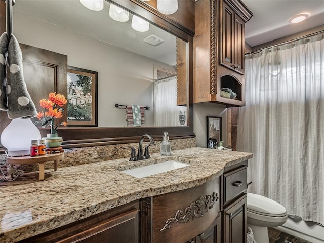 bathroom with a shower with shower curtain, visible vents, toilet, and vanity