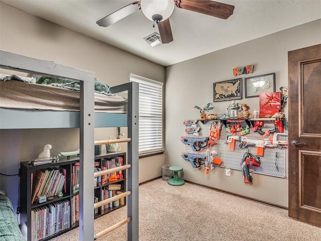 bedroom with visible vents, baseboards, carpet, and ceiling fan