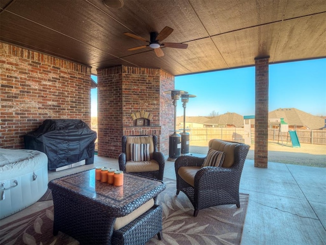 view of patio / terrace with a ceiling fan, fence, an outdoor brick fireplace, a playground, and a grill