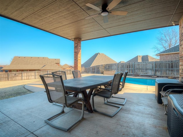 view of patio with a fenced in pool, a ceiling fan, outdoor dining area, and a fenced backyard